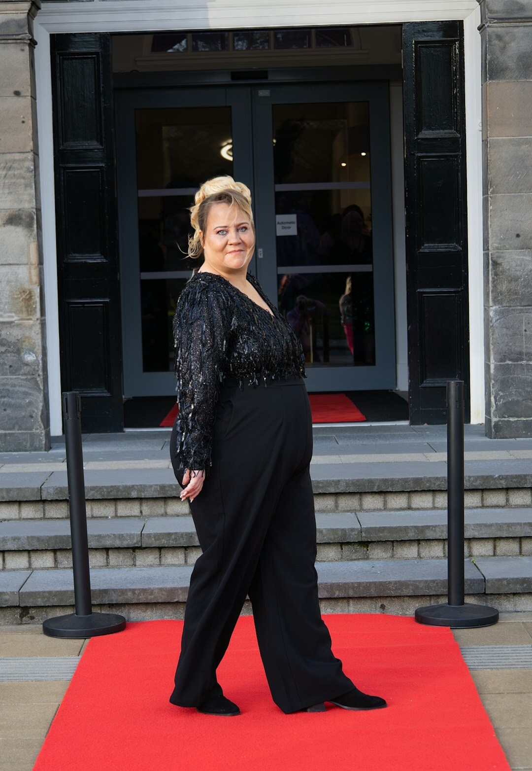 Hem of a formal evening gown on a red carpet